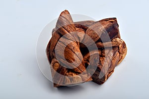 Dried melon in the form of plait on cut melons isolated on white background