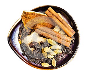 Dried Mulling spices in ceramic bowl isolated