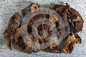 Dried mushroom pieces on rustic surface