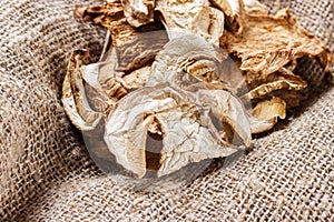 dried mushroom on sackcloth. Top view dried porcini mushrooms