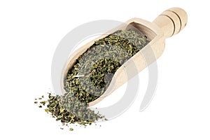 dried nettle herb or in latin Utricae folium in wooden scoop isolated on white background. medicinal healing herbs. herbal medicin