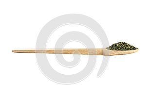 dried nettle herb or in latin Utricae folium in wooden spoon isolated on white background. medicinal healing herbs. herbal medicin