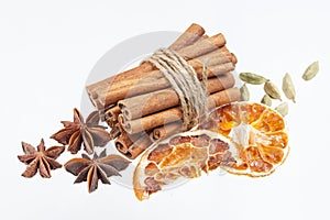 Dried orange, anise stars and cinnamon sticks isolated on white background