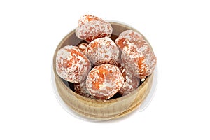 Dried orange mandarins in a wooden bowl