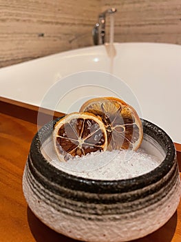 Dried oranges in bowl of bath salts portrait view