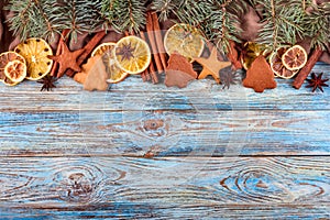 Dried oranges, star anise, cinnamon sticks and gingerbread on a blue wooden background -- Christmas background