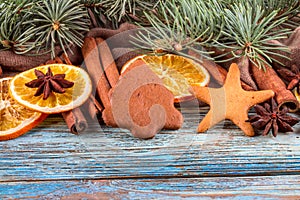 Dried oranges, star anise, cinnamon sticks and gingerbread on a blue wooden background -- Christmas background