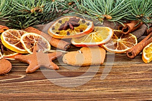 Dried oranges, star anise, cinnamon sticks and gingerbread on a wooden background -- Christmas background