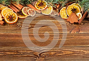 Dried oranges, star anise, cinnamon sticks and gingerbread on a wooden background -- Christmas background