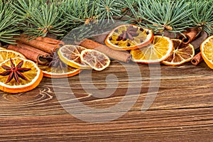 Dried oranges, star anise, cinnamon sticks and gingerbread on a wooden background -- Christmas background