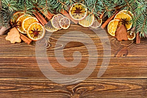 Dried oranges, star anise, cinnamon sticks and gingerbread on a wooden background -- Christmas background