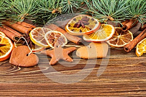 Dried oranges, star anise, cinnamon sticks and gingerbread on a wooden background -- Christmas background