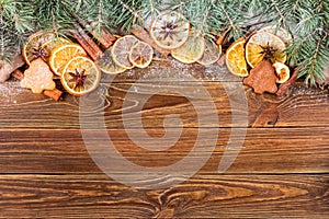 Dried oranges, star anise, cinnamon sticks and gingerbread on a wooden background -- Christmas sti