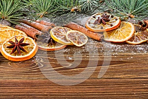 Dried oranges, star anise, cinnamon sticks and gingerbread on a wooden background -- Christmas sti