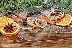 Dried oranges, star anise, cinnamon sticks and gingerbread on a wooden background -- Christmas sti