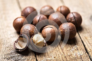 Dried organic Macadamia nuts in orange ceramic bowl