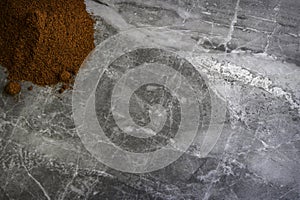 Dried organic smoked paprika powder on a marble kitchen worktop background photographed from above