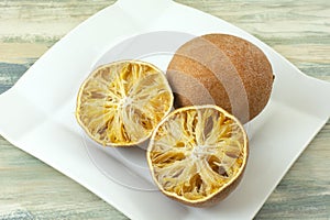 Dried out inedible oranges on plate