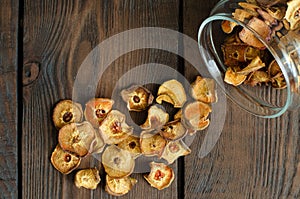 Dried pear from glass can on wooden background