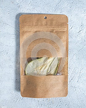 Dried pear in paper package close up