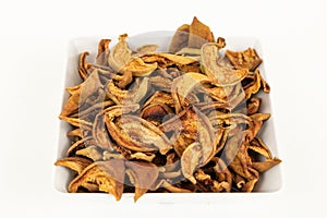 dried pear slices in white bowl on white background