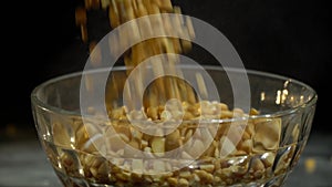 Dried peas are poured into a glass bowl