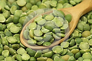 Dried peas in a wooden spoon