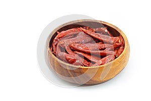 Dried pepper chillies in wooden bowl on white background