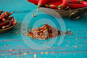 Dried pepper seeds and fresh chilli in background