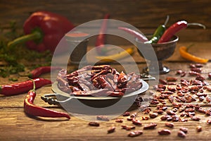 Dried peppers - chillies and others on a metal plate, rustic style