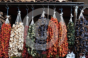 Dried peppers and eggplant hanging in a market