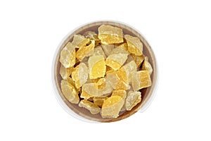 Dried pineapple slices in a wooden bowl