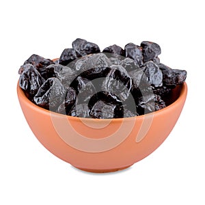 Dried plums or prunes in brown bowl isolated on white background, copy space.