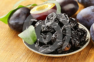 Dried plums prunes and fresh berries photo