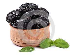 Dried plums - prunes in wooden bowl isolated on white