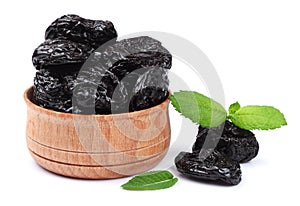 Dried plums - prunes in wooden bowl isolated on white