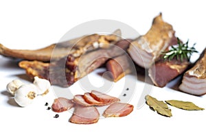 Dried pork meat smoked on traditional way with garlic , rosemary and pepper isolated on white background