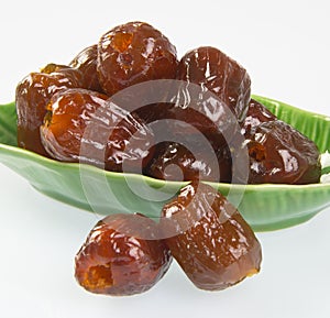 Dried preserved. Sweet syrup monkey apple or Chinese date on background