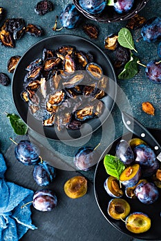 Dried prune and fresh plums with leaves