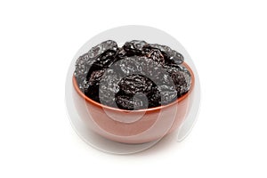 Dried prunes in bowl