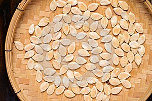 Dried pumpkin seeds in bamboo basket