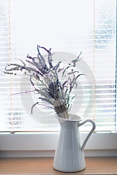 Dried purple lavender in vase on window. Mockup for positive idea. Empty place for inspirational, emotional, sentimental text.