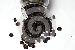 Dried raisin fruits in glass jar on display for sale