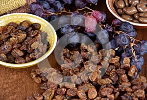 Dried raisins with a bunch of grapes stock images