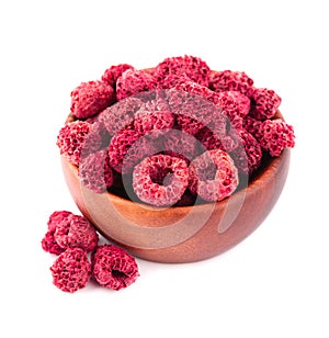 Dried raspberry isolated on white background. Dehydrated raspberry in wooden bowl