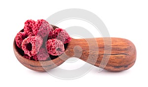 Dried raspberry isolated on white background. Dehydrated raspberry in wooden spoon