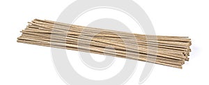 Dried raw japanese soba noodle sticks isolated on a white background