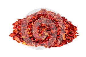 Dried red chili flakes with seeds, isolated on white background. Chopped chilli cayenne pepper. Spices and herbs.