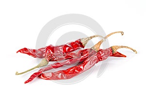 Dried red chili peppers on white background.