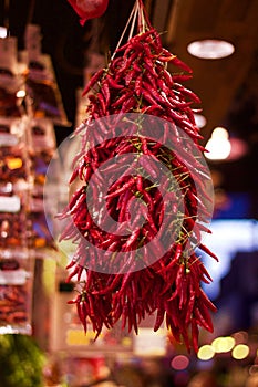 Dried red chillies hanging up for sale in market